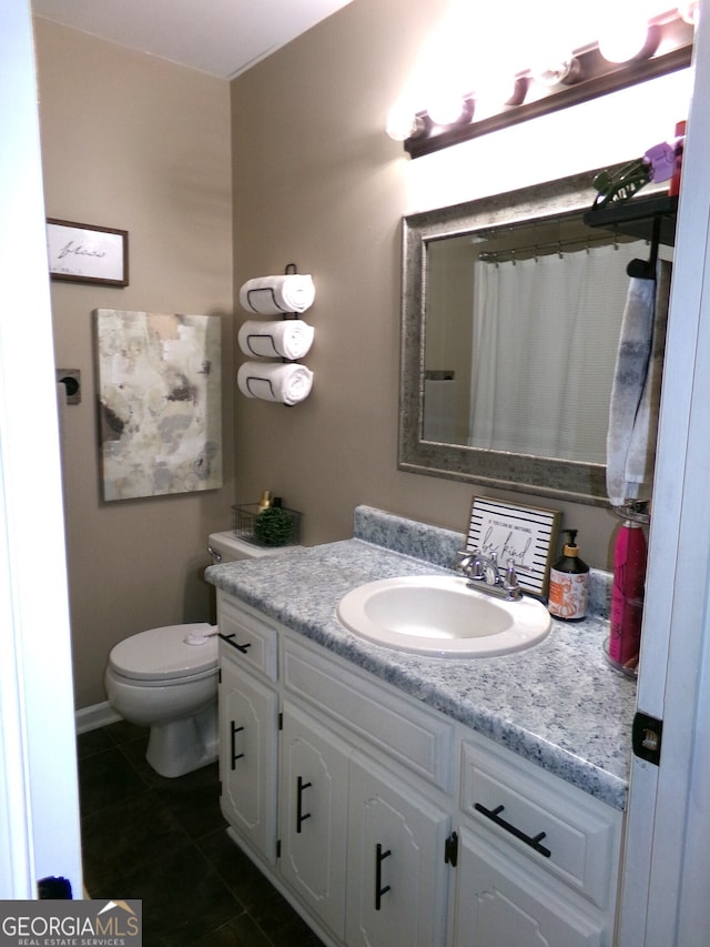 bathroom with vanity, toilet, and tile patterned floors