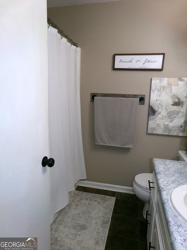 bathroom featuring vanity, toilet, tile patterned floors, and a shower with shower curtain