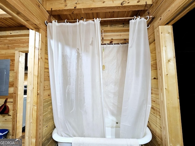 bathroom with electric panel and wooden walls