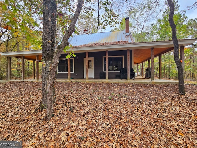 view of front of house with a patio and a carport
