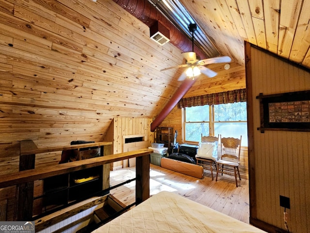 bedroom with wooden walls and vaulted ceiling