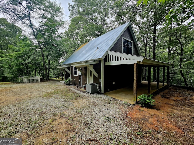 4153 Glenn Rd, Franklin, GA 30217 - view of side of home featuring metal roof, central AC unit, and dirt driveway