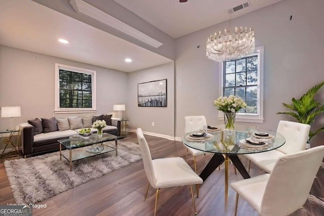 dining room with a notable chandelier and wood-type flooring