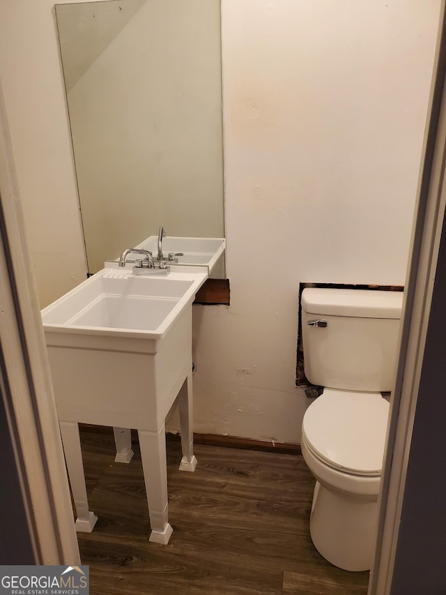 bathroom with wood-type flooring and toilet