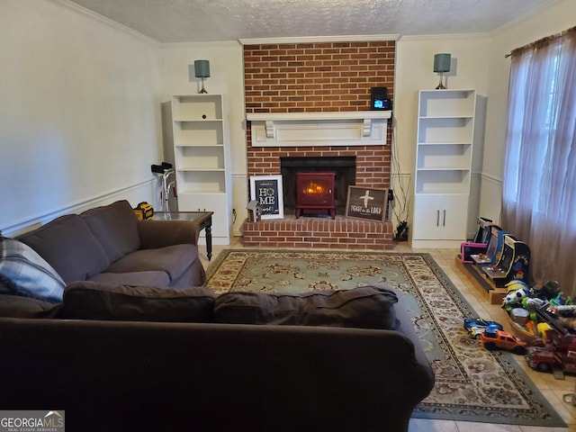 living room with tile patterned flooring, a fireplace, crown molding, and a textured ceiling