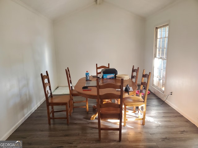 dining area featuring dark hardwood / wood-style floors, ornamental molding, and vaulted ceiling