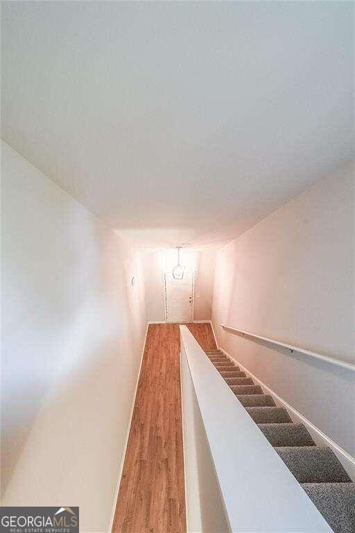 stairs with hardwood / wood-style floors