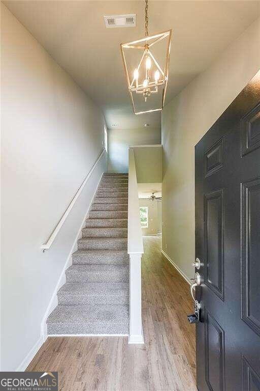 stairs with hardwood / wood-style floors