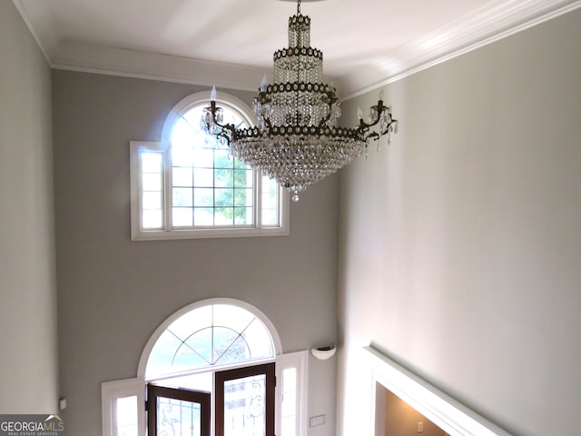 details featuring crown molding and a chandelier