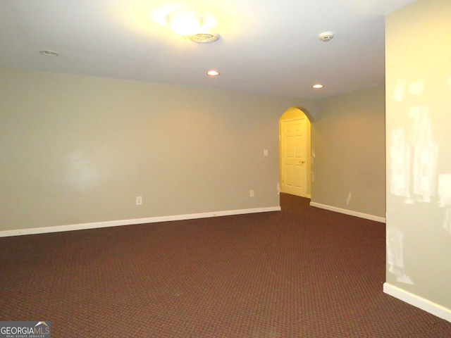 basement with dark colored carpet