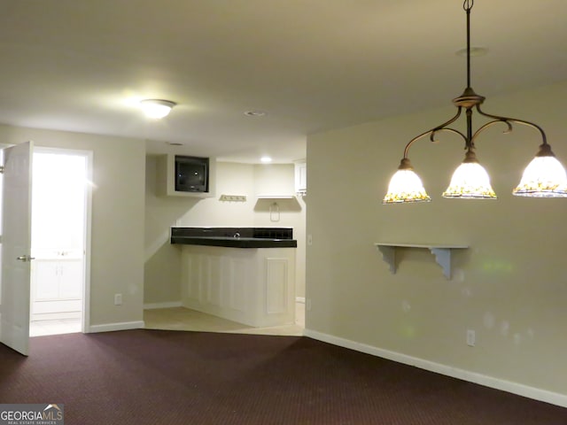 unfurnished living room with dark carpet