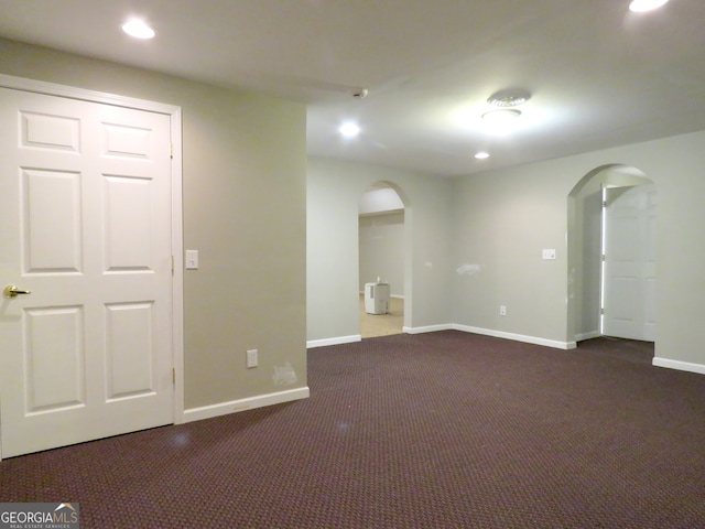 basement featuring dark colored carpet