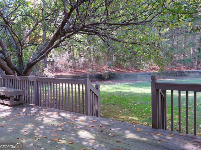 wooden terrace with a lawn