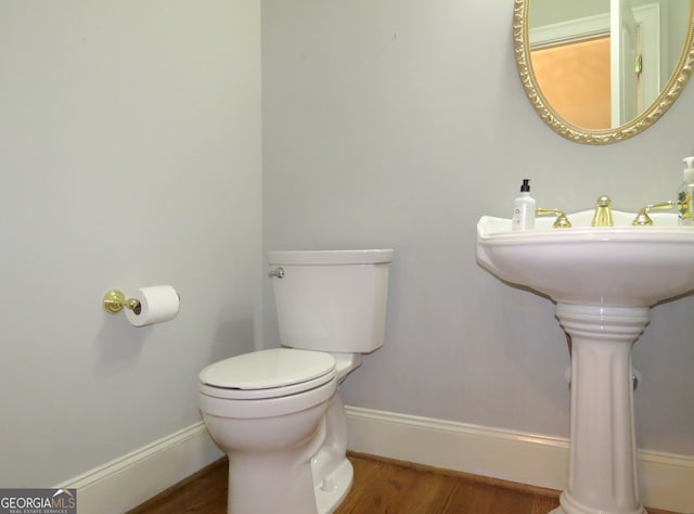 bathroom with toilet and wood-type flooring