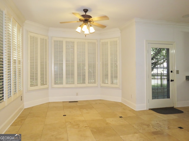 unfurnished dining area featuring crown molding and ceiling fan