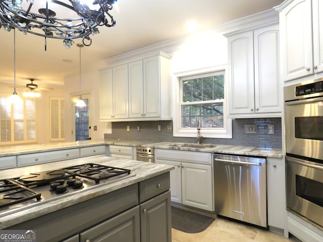 kitchen featuring white cabinets, stainless steel appliances, and pendant lighting