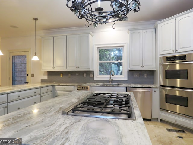 kitchen featuring white cabinetry, tasteful backsplash, stainless steel appliances, and sink