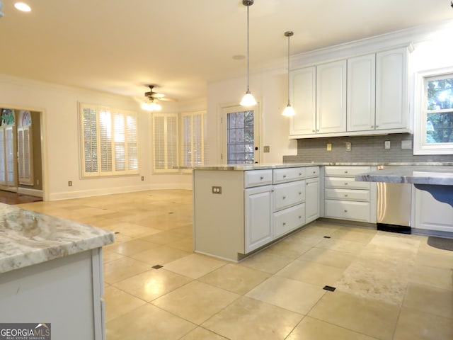 kitchen featuring decorative backsplash, light stone countertops, decorative light fixtures, white cabinetry, and ceiling fan