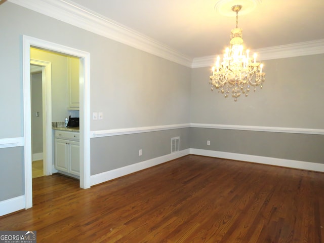 unfurnished room featuring ornamental molding, a chandelier, and dark wood-type flooring