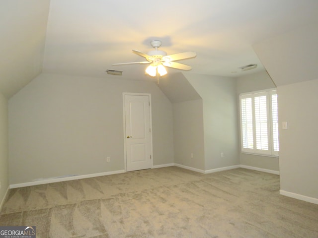 bonus room featuring ceiling fan, light carpet, and vaulted ceiling