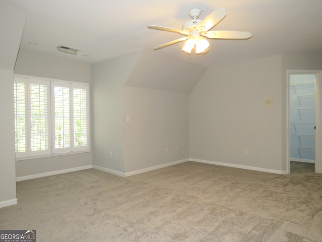 bonus room with light carpet, lofted ceiling, and ceiling fan