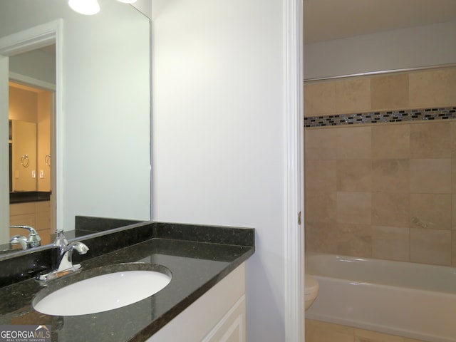 bathroom featuring vanity, toilet, and tile patterned flooring