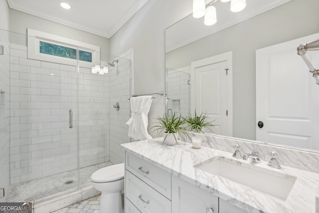 bathroom with vanity, ornamental molding, toilet, and walk in shower