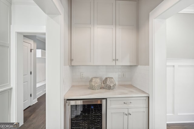 bar featuring white cabinetry, decorative backsplash, wine cooler, and dark hardwood / wood-style floors