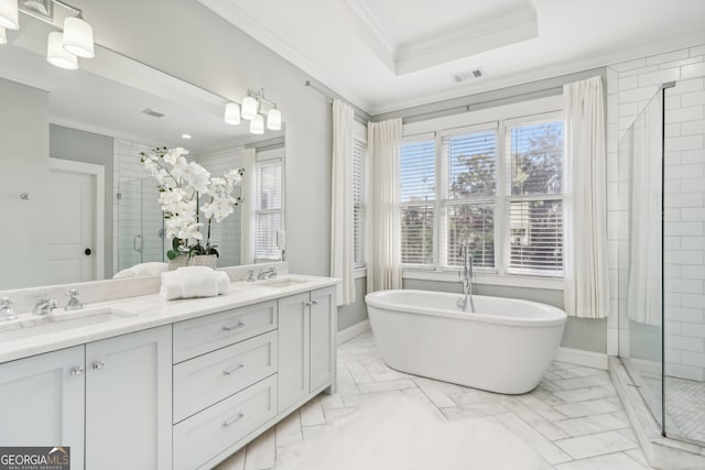 bathroom featuring vanity, crown molding, and shower with separate bathtub