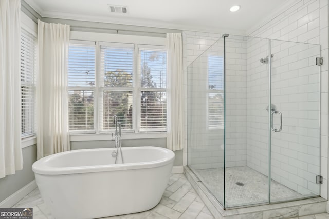 bathroom featuring shower with separate bathtub