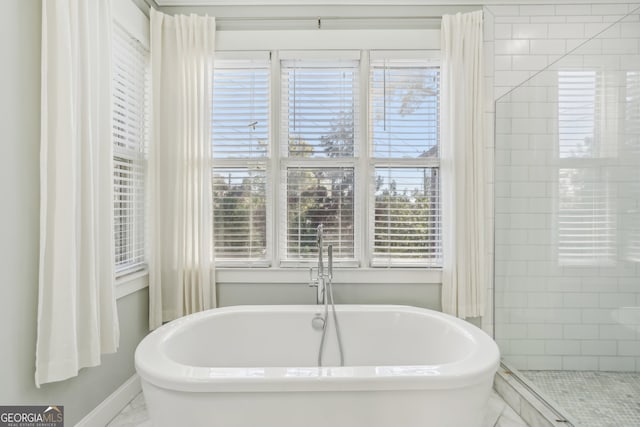 bathroom featuring separate shower and tub