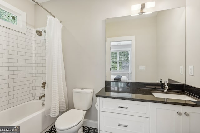 full bathroom with vanity, shower / bath combination with curtain, toilet, and tile patterned floors