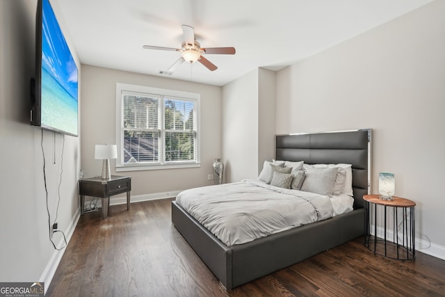 bedroom with dark hardwood / wood-style floors and ceiling fan