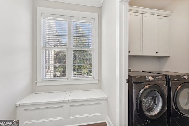 washroom with independent washer and dryer and cabinets