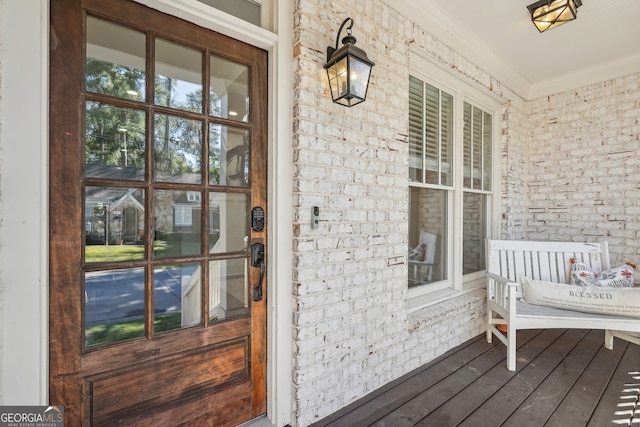 view of exterior entry featuring covered porch