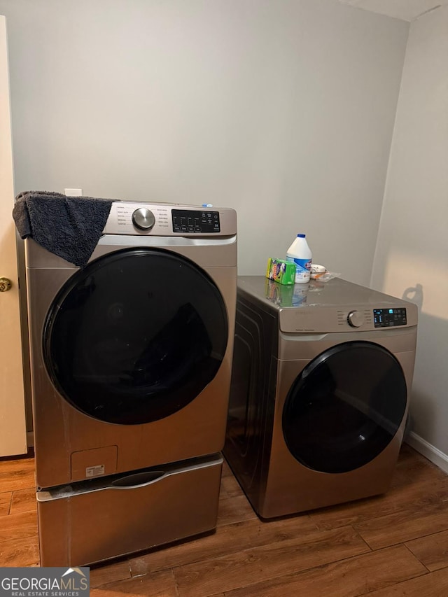 laundry area featuring light hardwood / wood-style flooring and washer and dryer