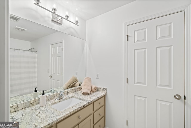 bathroom featuring vanity and a shower with shower curtain