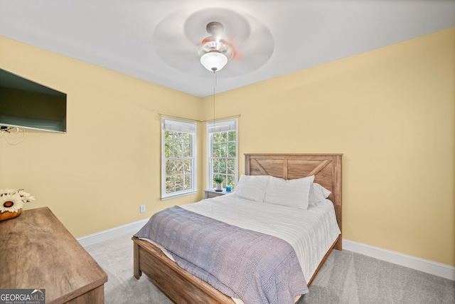 bedroom with ceiling fan and light colored carpet