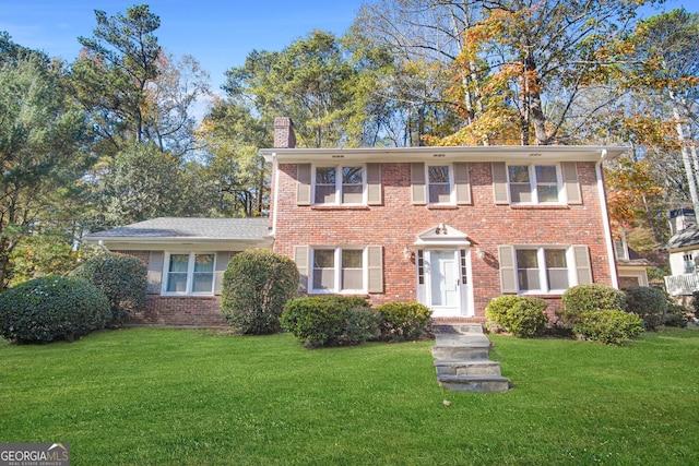 colonial-style house with a front lawn