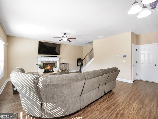 living room featuring ceiling fan and hardwood / wood-style floors