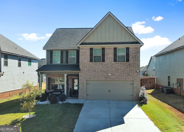 view of front facade featuring central AC, a front yard, and a garage