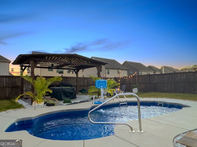 view of pool at dusk