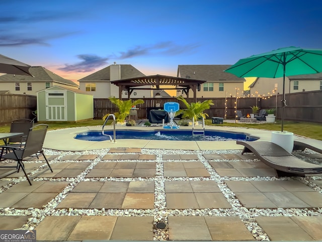 pool at dusk featuring a patio, a shed, and a playground