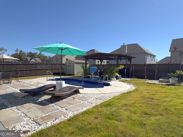 view of swimming pool with a yard, a patio area, a gazebo, and a shed