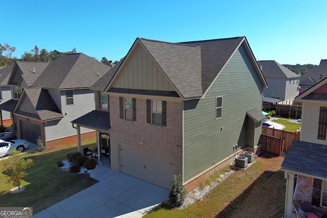 view of side of home featuring central AC and a garage