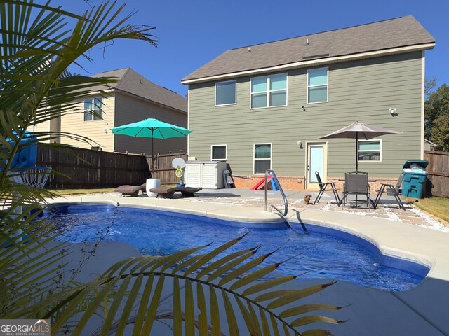 view of pool featuring a patio and grilling area