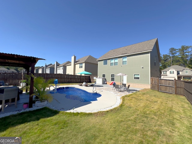 view of pool featuring a patio and a yard