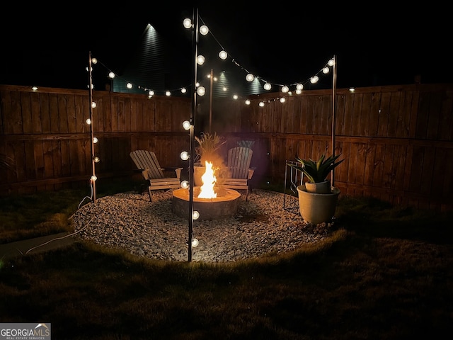 yard at twilight featuring a fire pit