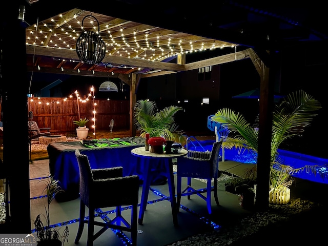 patio at twilight featuring exterior bar and a pergola