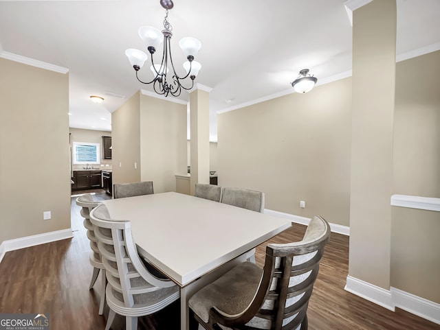 dining room featuring an inviting chandelier, ornamental molding, and dark wood-type flooring